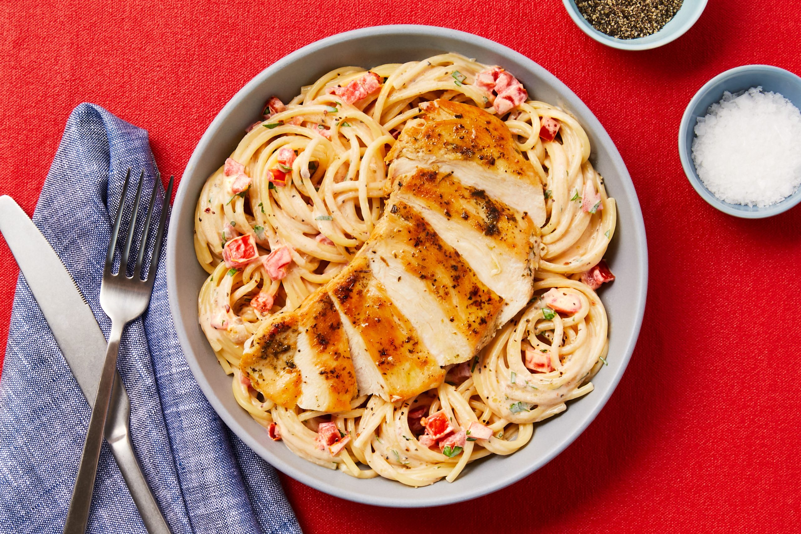 Creamy Aglio E Olio Chicken Pasta with Chili Flakes, Roma Tomato & Chopped Parsley
